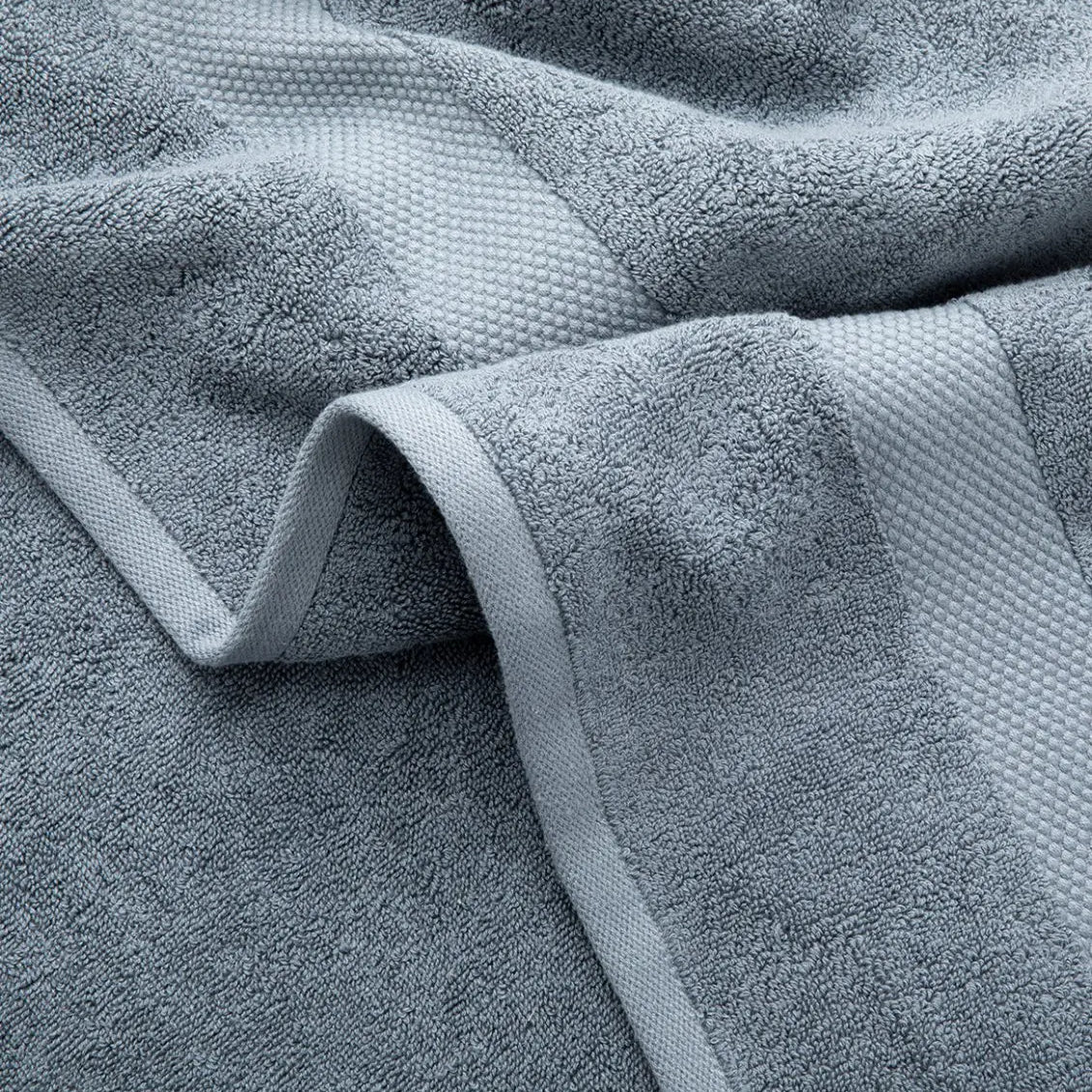 Close-up of a textured blue Premium Turkish Cotton towel with a soft finish