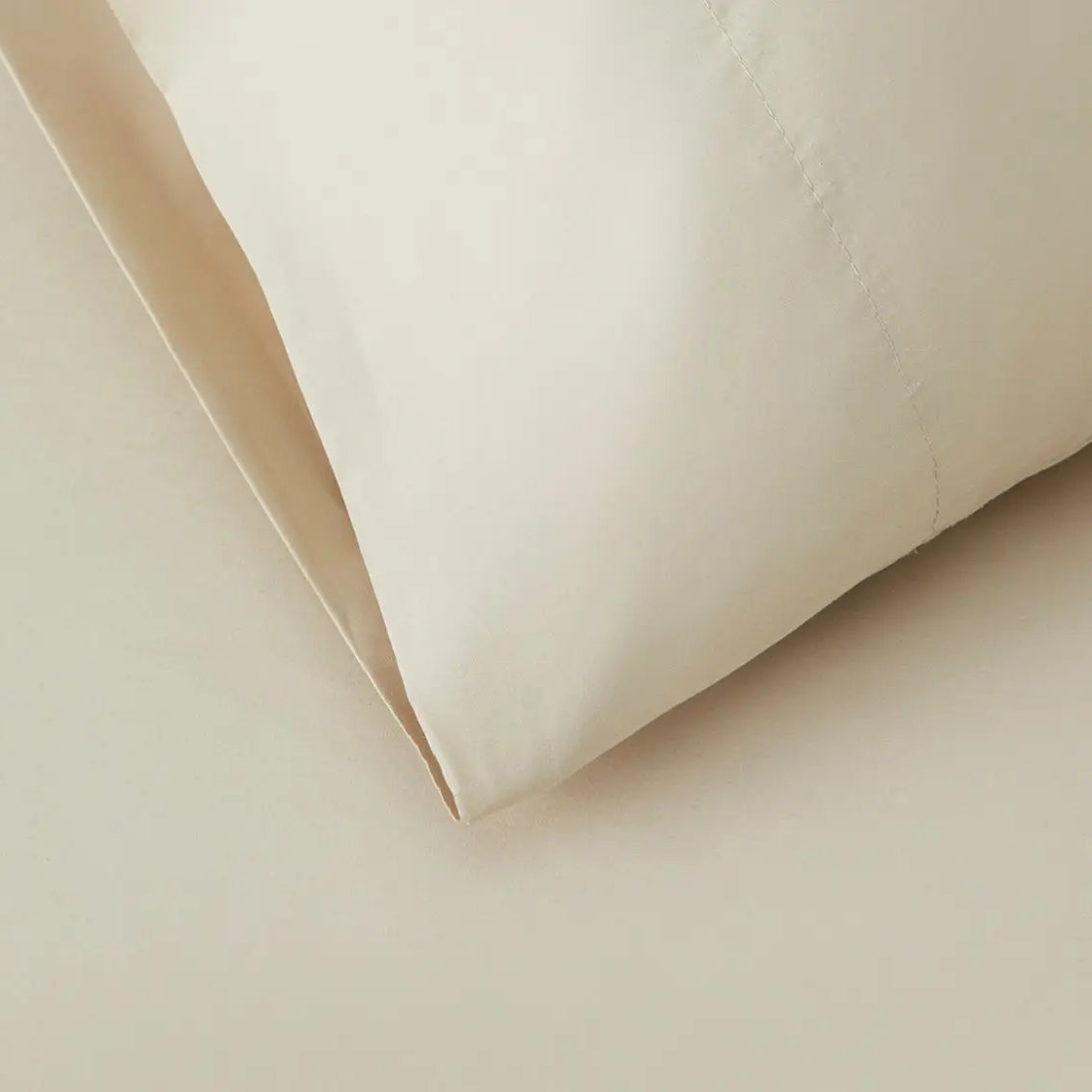 Close-up of beige sheet set fabric with a soft texture