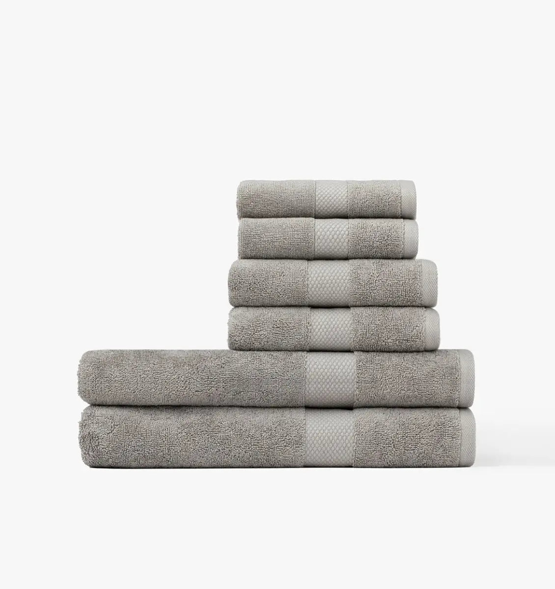 Stack of gray Premium Turkish Cotton towels on a white background