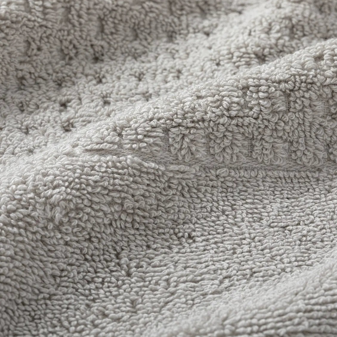 Close-up of light gray waffle towel fabric texture
