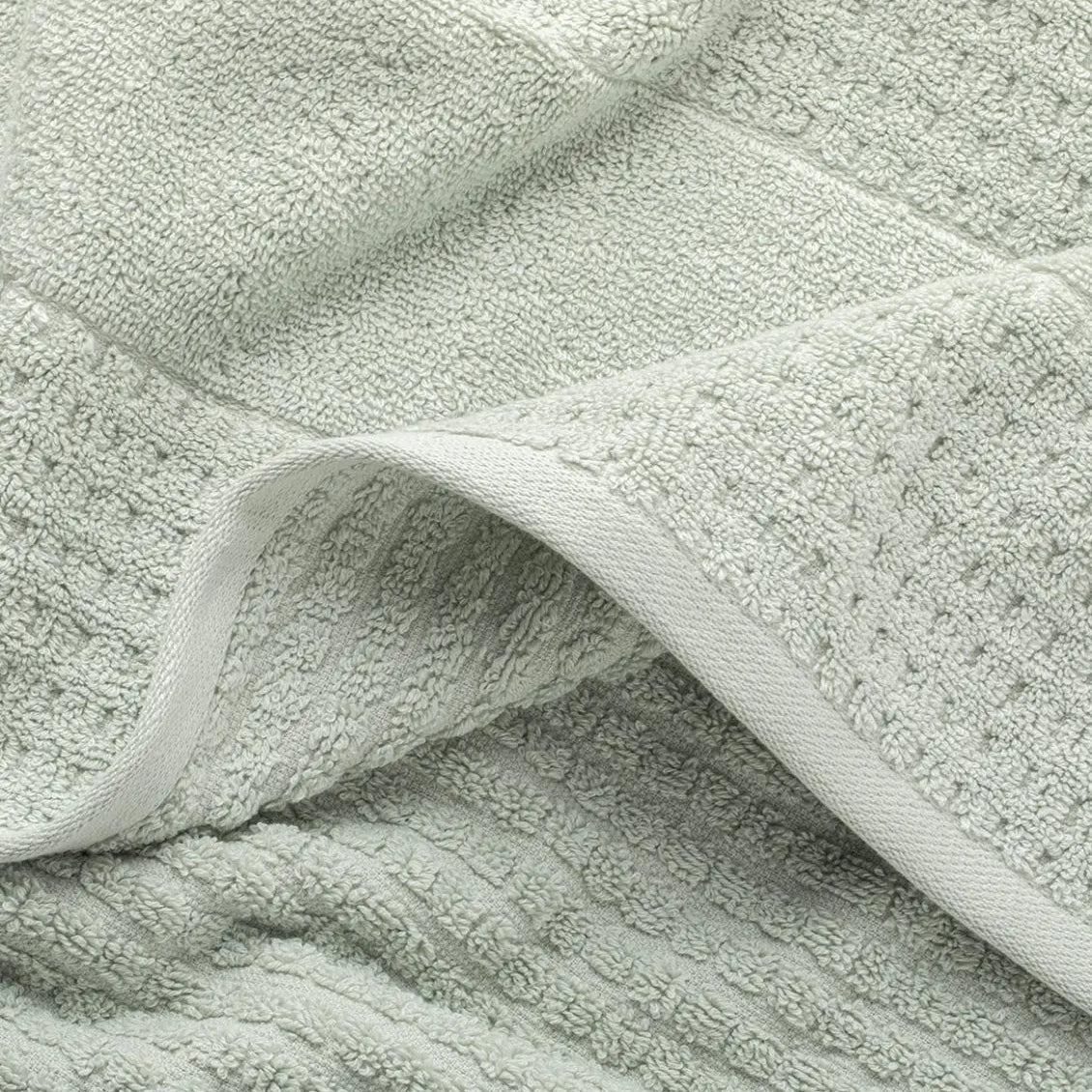 Close-up of a textured light green mist waffle towel