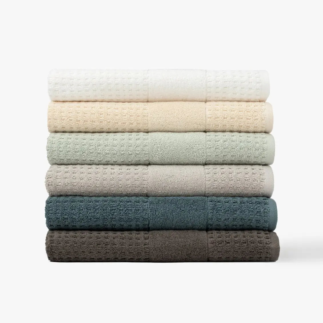 Stack of lightweight waffle towels in various colors