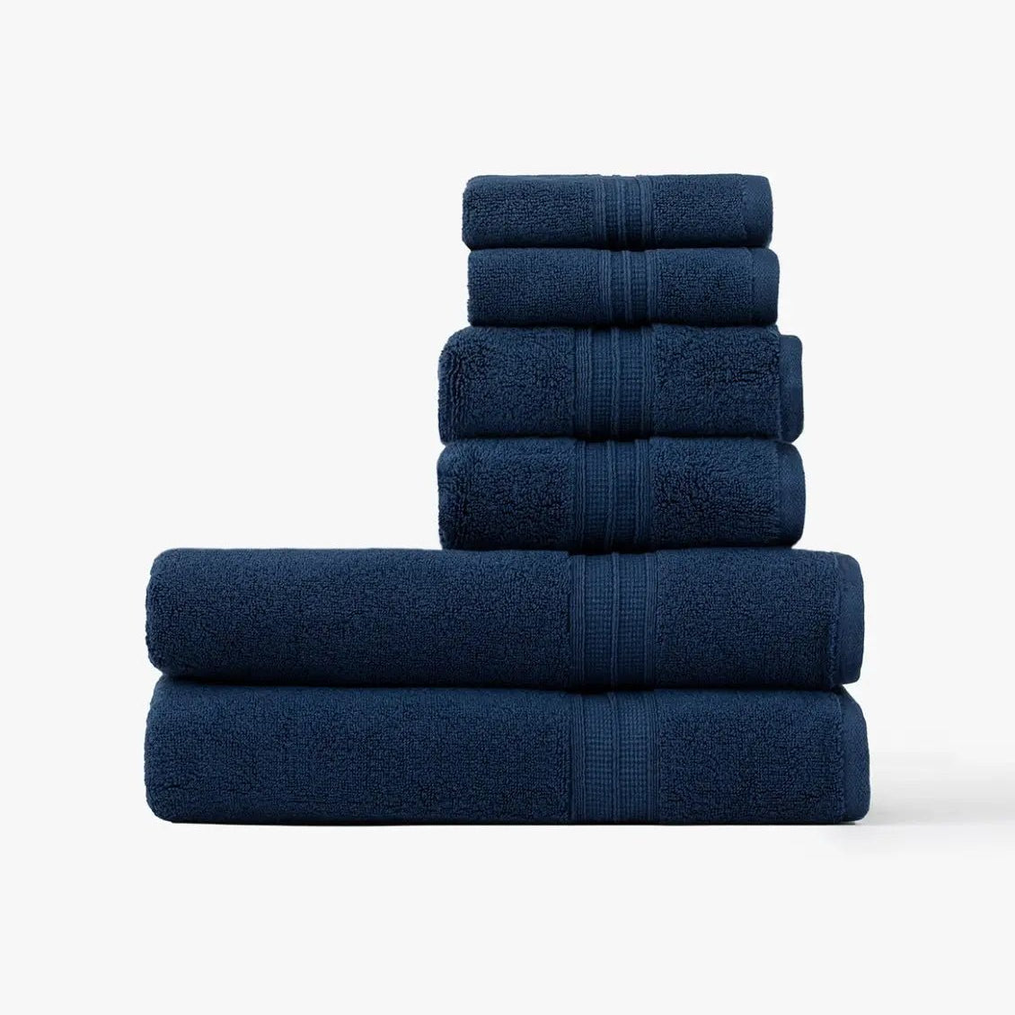 Stack of navy blue towels on a white background