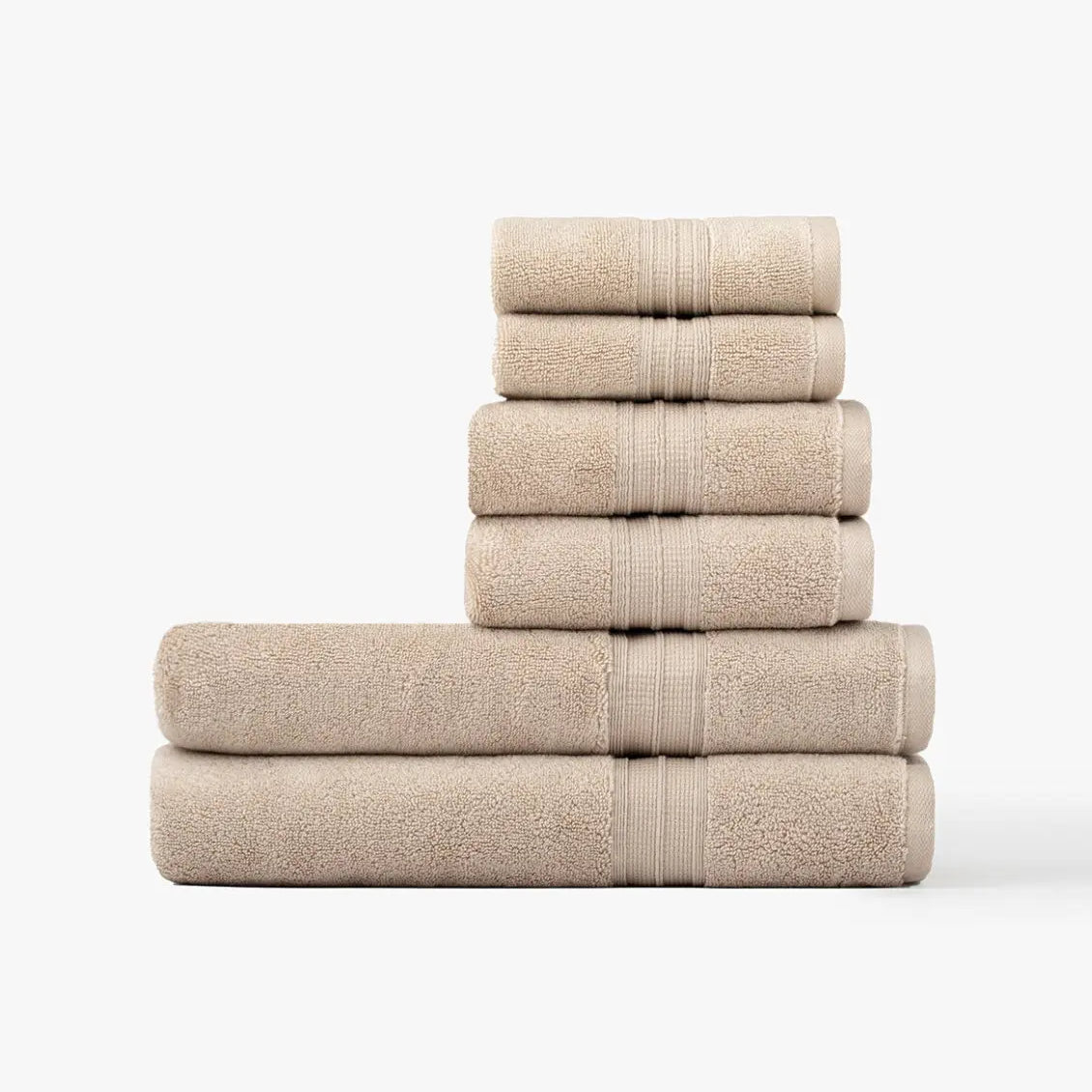 Stack of super plush taupe towels on a white background
