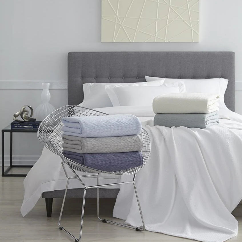 Sferra Corino Blankets shown on a bed | Duman Home