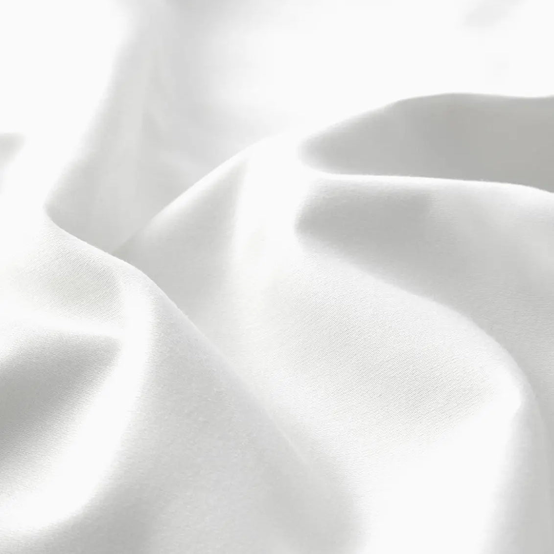 Close-up of white sheet set fabric with folds