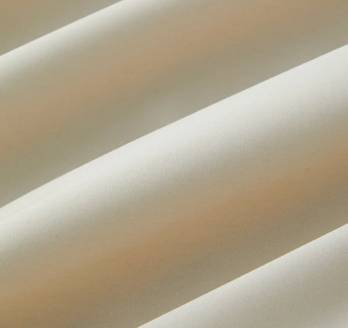 Close-up of beige sheet set fabric with a soft texture