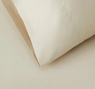 Close-up of beige sheet set fabric with a soft texture