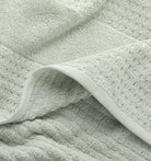 Close-up of a textured light green mist waffle towel