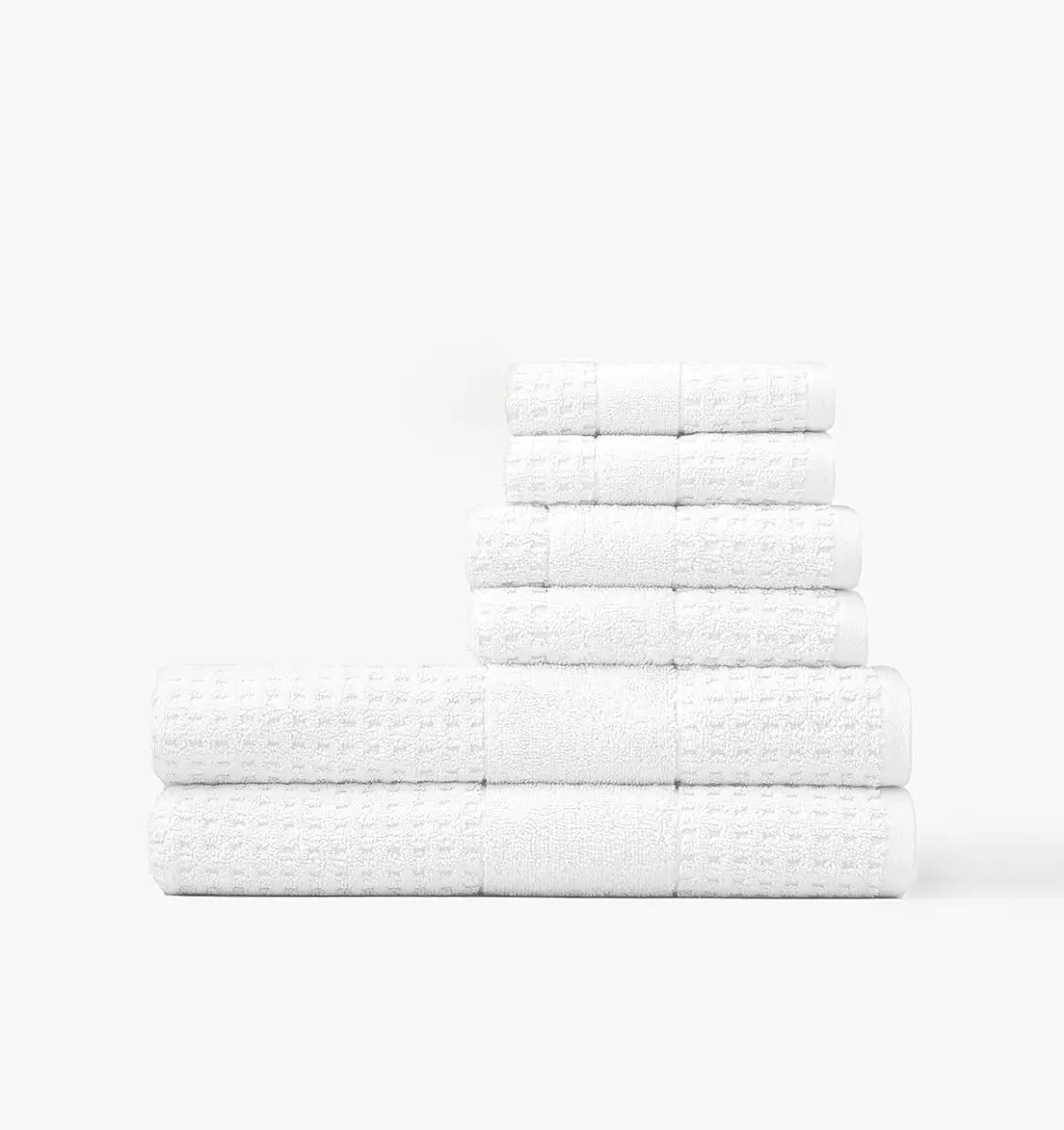 Stack of white waffle towels on a white background