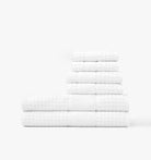 Stack of white waffle towels on a white background