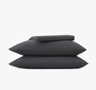 Slate gray bedding sheet set, including two pillows and a duvet on a white background