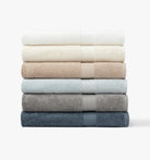 Stack of folded Premium Turkish Cotton towels in various colors on a white background