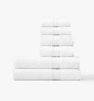 Stack of super plush white towel bundle on white background