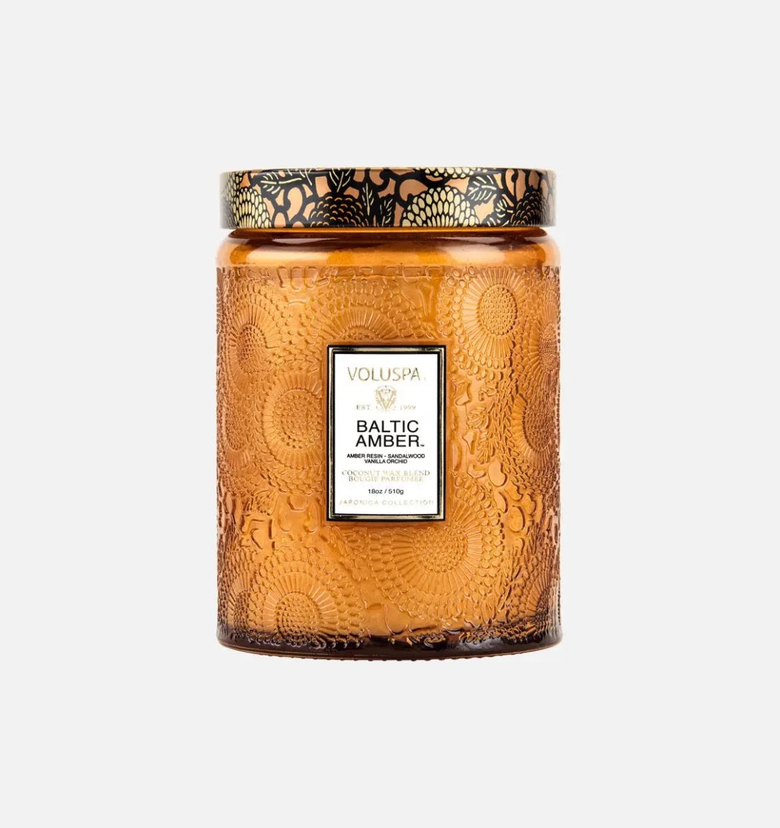 Voluspa baltic amber decorative candle in a textured glass jar with a gold pattern lid 