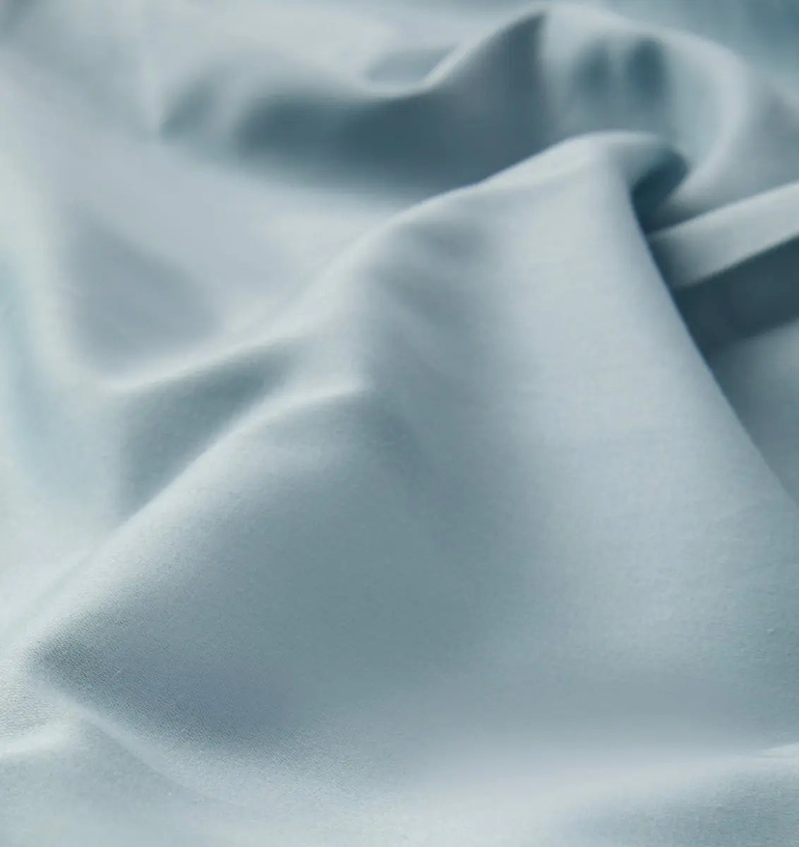 Close-up of textured light blue sheet set fabric