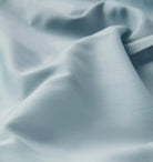 Close-up of textured light blue sheet set fabric