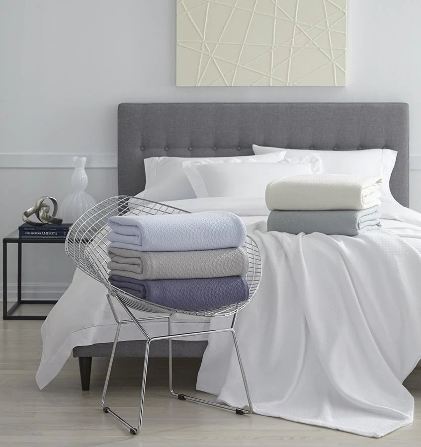 Sferra Corino Blankets shown on a bed | Duman Home